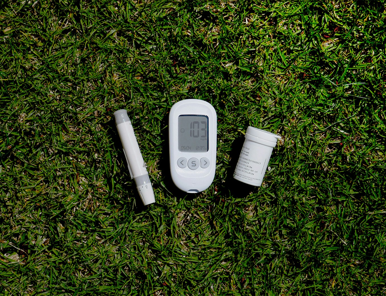 a thermometer, a thermometer, and a pill on the grass